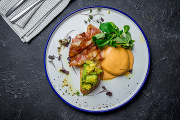 eggs Benedict with bacon and avocado
