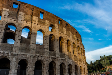 Fototapeta premium Golden sunset at the Great Roman Colosseum (Coliseum, Colosseo), also known as the Flavian Amphitheatre. Famous world landmark. Scenic urban landscape.