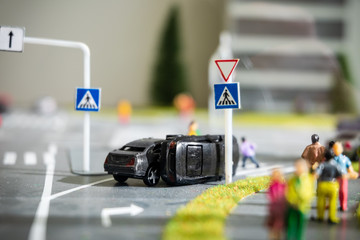 Miniature model of street intersection and car accident imitation