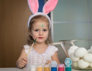 Girl paint easter eggs