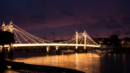 Albert bridge illuminated by lights at night with traffic