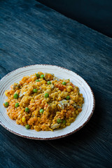 Lentil porridge with vegetables and herbs. Healthy lifestyle. Dietary menu. Dark wooden background. Side view.