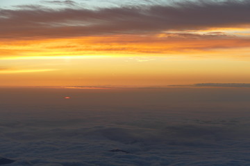 Fototapeta na wymiar Sunrise over the clouds from the top of Mount Fuji, Japan