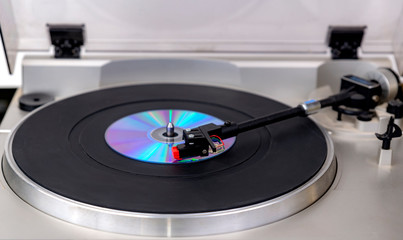 Playing a CD on a record turntable.