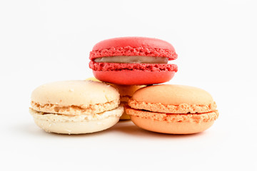 Close up of group of three sweet French macarons isolated on white, pastel colors