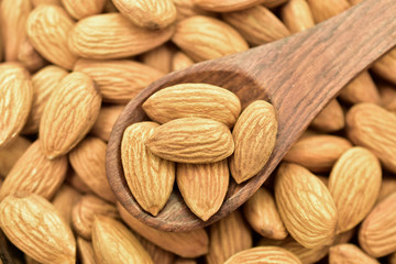 almonds in a wooden spoon, badam