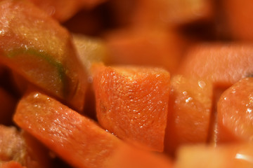 fried carrot pieces macro blurred background