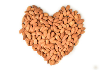 Almonds in heart shape on white background. Isolated. Healthy eating concept
