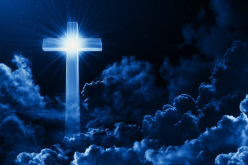 Concept of christian religion shining cross on the background of cloudy night sky. Dark sky with...