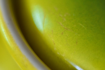 ceramic smooth surface of mustard color rounded shapes, fragment