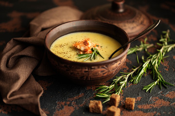Fish cream soup with Salmon, cheese, Potatoes and herbs in white Soup Bowls.
