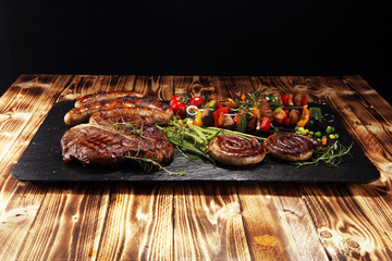 Assorted delicious grilled meat with vegetable on a barbecue with steak