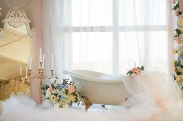 Bath on lion's Golden paws. The atmosphere of romance and love. Light interior, chiffon, flowers.