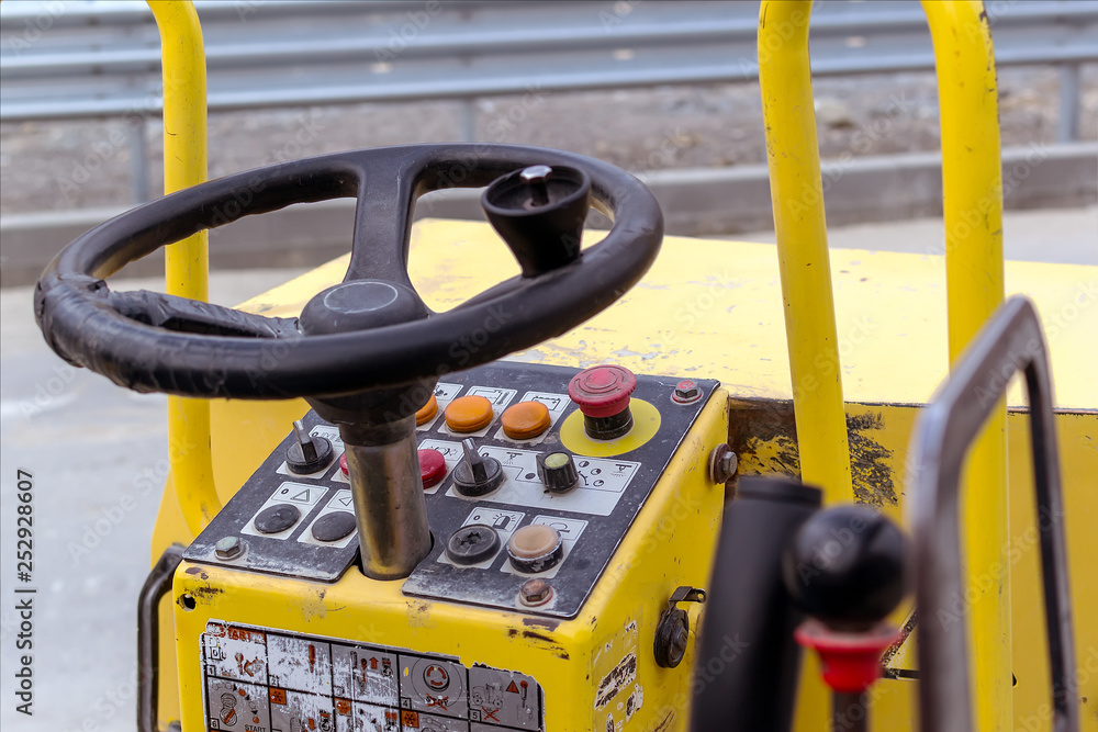 Wall mural Steering wheel and control panel of road roller compactor or vibratory roller for tamping asphalt and soil.