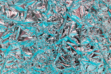 Holographic texture wrinkled metal foil. Hologram abstract 80s style background with blue, purple and silver colors. Texture of kaleidoscope, webpunk and vaporwave concept