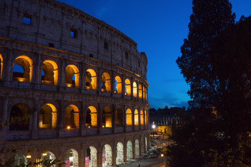 Fototapeta na wymiar Night at the Great Roman Colosseum (Coliseum, Colosseo), also known as the Flavian Amphitheatre with lights & illumination.