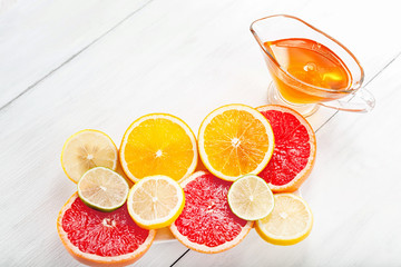 Various fruits in a cut on a white background with honey