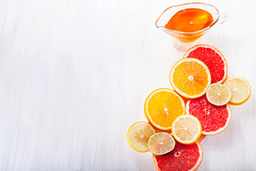 Various fruits in a cut on a white background with honey