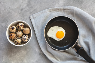Quail egg fried in a pan. Fresh organic egg.
