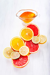 Various fruits in a cut on a white background with honey