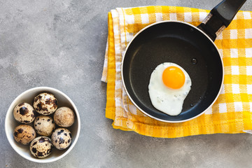 Quail egg fried in a pan. Fresh organic egg.