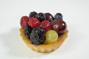 Cake with fresh bio fruits, grapes, raspberries, blackberries, side view photo, white background, isolate