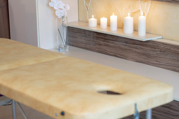 a cozy room for a relaxing massage with a couch and candles