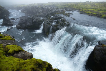 Icy blue waterfall on waterfall trail, stage one of Fimmvörduhals mountain pass, Iceland