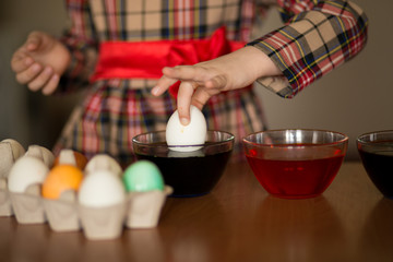 Happy easter. Little girl painter painted eggs. Kid preparing for Easter. Painted hand. Art and craft concept. Traditional spring holiday food