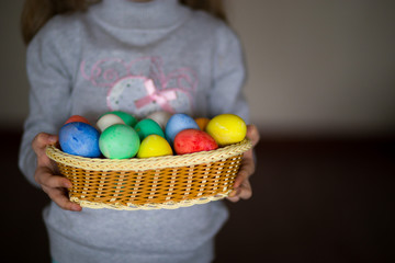 Fototapeta na wymiar Cute little girl with bunny ears holding bright Easter egg