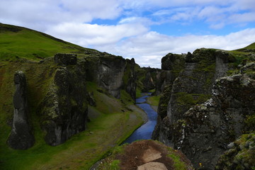 View into Fjadrargljufur canyon with deep blue river, Iceland