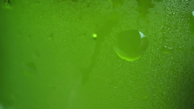 Closeup: beer bubbles floating up in the green beer bottle.