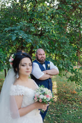 Newlyweds on their wedding day stand apart from each other.