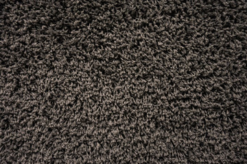 Fototapeta premium Black racpet textile texture close up on the wall
