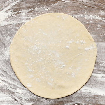 Rolled Out Pizza Dough On Floured Surface