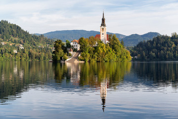 Fototapeta na wymiar Church of the assumption of Mary in the island of Bled lake, Slovenia, with reflects in the water