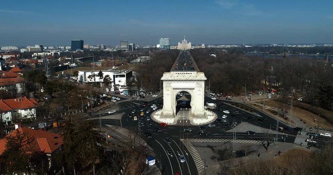 Aerial footage of an arch and boulevards surrounding it on a sunny day in Bucharest.