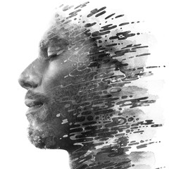 Paintography. Double exposure of a young male model combined with hand drawn painting of dissolving ink texture