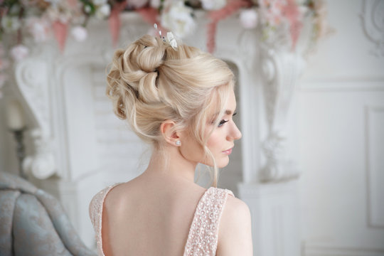 Elegant wedding hairstyle on a beautiful bride blonde rear view.