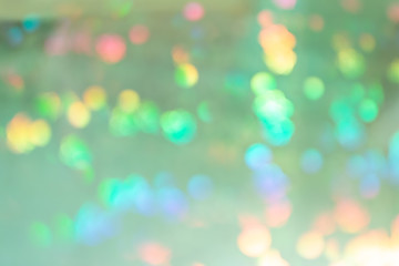 Fototapeta premium Pale green abstract background with colorful blots in blur.