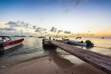 Fototapeta premium Wooden pier at sea with a beautiful sunset at Las Aves Island, Venezuela.