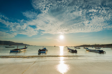 Boats anchored during a dramatic and beautiful sunset in Juan Griego beach, Margarita Island,...