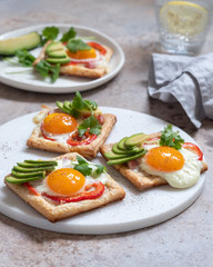 Baked puff pastry with fried egg, pepper and avocado