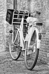 Retro style white bicycle parked against a brick wall, Amsterdam, The Netherlands