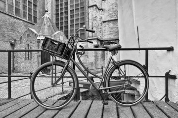 Fototapeta na wymiar Retro style black bicycle parked against a railing, Gouda, The Netherlands