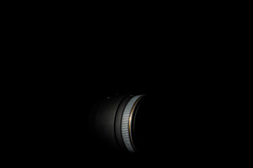 Underexposed photo of DSLR lens. Stock photo isolated on black background. Low light photo. A large depth of field.