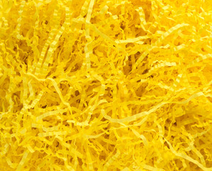 background texture-close up of bright yellow crinkled paper Easter grass