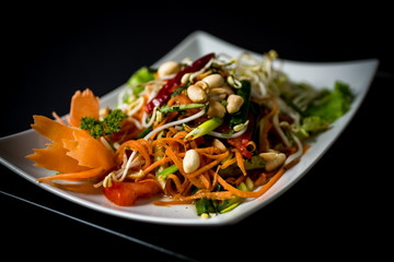 Papaya salad (Som Tam) , Thai food. Four essential flavors of Thailand. Sour, sweet, spicy and exotic. Served with homemade chili sauce.