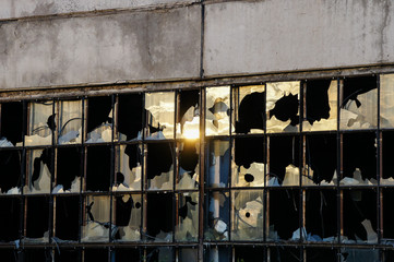 Dirty broken glass in the window of an abandoned building