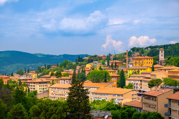 Fototapeta premium Perugia, Italy - Panoramic view of the Perugia historic quarter with medieval houses and Umbria valleys and mountains in background